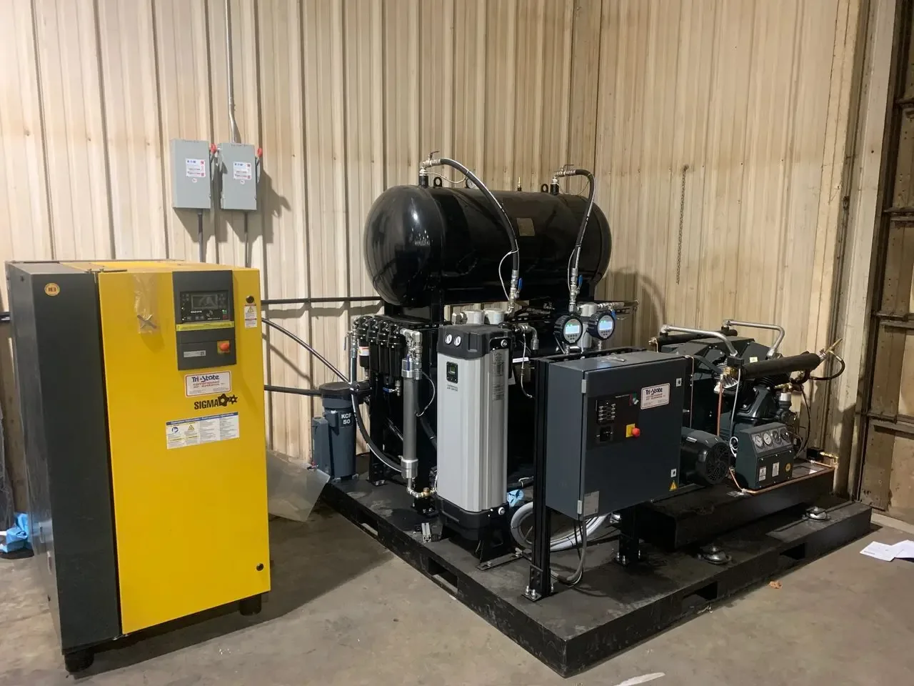 Booster compressor system set-up in an industrial building