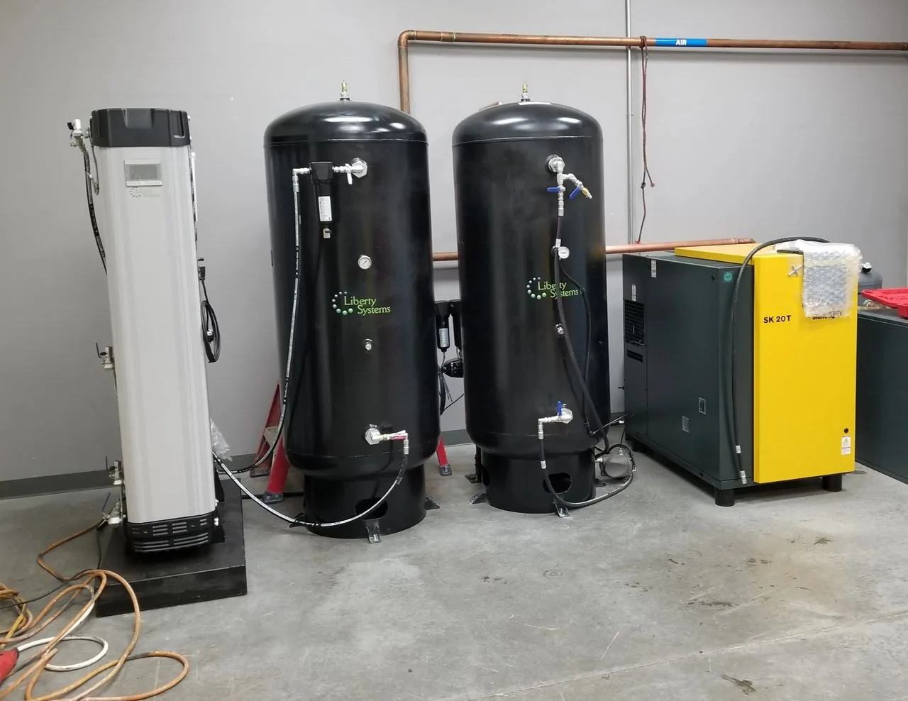 Two compressed air and nitrogen tank systems set up within a building